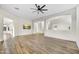 Spacious living room with wood-look tile flooring and modern ceiling fan at 32806 N 55Th Pl, Cave Creek, AZ 85331