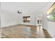 Spacious living room with modern ceiling fan and light hardwood flooring at 32806 N 55Th Pl, Cave Creek, AZ 85331