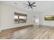 Spacious living room with wood-look tile flooring and modern ceiling fan at 32806 N 55Th Pl, Cave Creek, AZ 85331