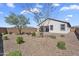 This backyard has desert landscaping and a covered patio space at 3309 E Malibu Dr, San Tan Valley, AZ 85143