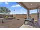 Covered patio with neutral hardscape and desert landscaping, offering a relaxing outdoor space at 3309 E Malibu Dr, San Tan Valley, AZ 85143