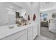 Bathroom with double sinks, a large mirror, and a view into the main bedroom at 3309 E Malibu Dr, San Tan Valley, AZ 85143