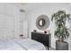 A clean bedroom with a double bed, neutral decor, and a large potted plant at 3309 E Malibu Dr, San Tan Valley, AZ 85143