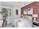 A cozy bedroom with an accent wall, a chandelier, and whimsical decor at 3309 E Malibu Dr, San Tan Valley, AZ 85143