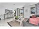 Cozy living room with sliding glass doors to the backyard and a comfortable gray sofa at 3309 E Malibu Dr, San Tan Valley, AZ 85143