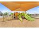 Community playground with multiple play structures under a large shade at 3309 E Malibu Dr, San Tan Valley, AZ 85143