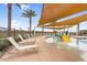 Community pool area featuring a shallow water play area, lounge chairs, and palm trees at 3309 E Malibu Dr, San Tan Valley, AZ 85143