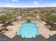 Aerial view of pool and splash pad with lounge seating and surrounding community at 3347 E Malibu Dr, San Tan Valley, AZ 85143