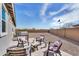 This desert landscaped backyard patio has comfortable seating, a barbecue, and beautiful outdoor desert scenery at 3347 E Malibu Dr, San Tan Valley, AZ 85143