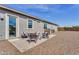 This backyard includes a patio with a seating area, a barbecue grill, and desert landscaping at 3347 E Malibu Dr, San Tan Valley, AZ 85143