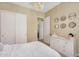 A bright bedroom features neutral decor, plush carpet, a closet and soft lighting creating a cozy and inviting space at 3347 E Malibu Dr, San Tan Valley, AZ 85143