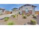 Well-maintained home featuring desert landscaping, a stone facade, and a two-car garage enhancing its curb appeal at 3347 E Malibu Dr, San Tan Valley, AZ 85143