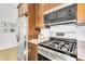 Cozy kitchen featuring stainless steel appliances, a gas range, and warm wood cabinetry at 3347 E Malibu Dr, San Tan Valley, AZ 85143