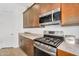 Close-up of a modern kitchen featuring stainless steel appliances, sleek cabinetry, and updated countertops at 3347 E Malibu Dr, San Tan Valley, AZ 85143