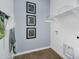 Functional laundry room includes wall decorations, a shelf and an easily accessible washing machine hookup at 3347 E Malibu Dr, San Tan Valley, AZ 85143