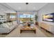 Bright living room featuring large sliding glass doors, modern lighting, and comfortable seating with backyard views at 3347 E Malibu Dr, San Tan Valley, AZ 85143