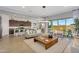 Spacious living room connects to a modern kitchen and dining area with backyard access through sliding glass doors at 3347 E Malibu Dr, San Tan Valley, AZ 85143