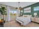 Cozy main bedroom featuring a decorative green accent wall, bench, and bright natural lighting at 3347 E Malibu Dr, San Tan Valley, AZ 85143