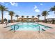 Resort-style pool featuring palm trees, sunshades, and lounge chairs perfect for relaxation and fun at 3347 E Malibu Dr, San Tan Valley, AZ 85143