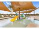 Community splash pad under shaded canopy with kid friendly water features at 3347 E Malibu Dr, San Tan Valley, AZ 85143