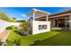 Inviting backyard with synthetic grass, a modern fireplace, and a view of the pool area at 3522 E Penedes Dr, Gilbert, AZ 85298