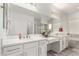 Bright bathroom with dual sinks, vanity area, and large mirror with a glass door shower at 3522 E Penedes Dr, Gilbert, AZ 85298