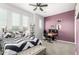 Bright bedroom features a bed, desk and workstation, and multiple windows offering natural light at 3522 E Penedes Dr, Gilbert, AZ 85298