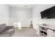 This is a large bedroom, with a TV, guitar, doors, carpet, and a dresser at 3522 E Penedes Dr, Gilbert, AZ 85298