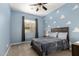 Bedroom with a bed, gray carpet and blue walls with cloud patterns, and a window with gray curtains at 3522 E Penedes Dr, Gilbert, AZ 85298