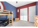 bedroom with a bunk bed, closet with white doors, gray carpet, and blue and red walls at 3522 E Penedes Dr, Gilbert, AZ 85298