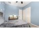 Bedroom with a bed, gray carpet and blue walls with cloud patterns, and a modern dresser with white doors at 3522 E Penedes Dr, Gilbert, AZ 85298
