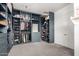 Spacious walk-in closet with custom blue cabinetry, shelving and lighting, offering ample shoe and clothing storage at 3522 E Penedes Dr, Gilbert, AZ 85298