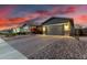 Charming single Gathering home with a grey exterior, brick driveway, and well-manicured landscaping at 3522 E Penedes Dr, Gilbert, AZ 85298