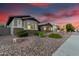 View of the front of the home showing the desert landscaping and neighborhood at 3522 E Penedes Dr, Gilbert, AZ 85298