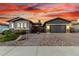 Charming single-Gathering home with a two-car garage, desert landscaping and a brick walkway leading to the front door at 3522 E Penedes Dr, Gilbert, AZ 85298
