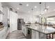 Spacious white kitchen with stainless steel appliances, a large island and a dining area at 3522 E Penedes Dr, Gilbert, AZ 85298