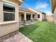 Private backyard with artificial turf, a covered patio, and low-maintenance landscaping at 4171 E Ronald St, Gilbert, AZ 85295