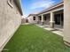Backyard features well maintained artificial grass and stepping stone walkway at 4171 E Ronald St, Gilbert, AZ 85295