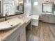 Luxurious bathroom featuring dual vanities, a soaking tub, a separate shower, and modern fixtures at 4171 E Ronald St, Gilbert, AZ 85295