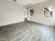Neutral bedroom with wood-look tile flooring, a bright window, and ample space at 4171 E Ronald St, Gilbert, AZ 85295
