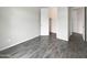 Neutral bedroom with wood-look tile flooring, ample closet space, and a bright window at 4171 E Ronald St, Gilbert, AZ 85295