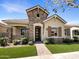 Charming single-story home featuring a stone facade, well-manicured landscaping, and a welcoming entryway at 4171 E Ronald St, Gilbert, AZ 85295
