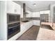 Modern kitchen with white cabinets, granite countertops, stainless steel appliances, and tile backsplash at 4171 E Ronald St, Gilbert, AZ 85295