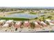 Aerial view of homes near a golf course and a serene lake, offering a blend of leisure and community at 4436 E Shomi St, Phoenix, AZ 85044