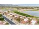 A picturesque aerial view of red-tiled roofs and lush golf course adjacent to a suburban neighborhood at 4436 E Shomi St, Phoenix, AZ 85044