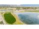 Aerial shot showcasing a golf course, lake, and desert landscape near a residential community at 4436 E Shomi St, Phoenix, AZ 85044