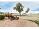 Outdoor grill area on a brick patio, overlooking a lake with mature landscaping and mountain views at 4436 E Shomi St, Phoenix, AZ 85044