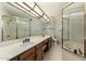 Bright bathroom featuring double sinks, a glass shower, and a soaking tub with gold trim at 4436 E Shomi St, Phoenix, AZ 85044