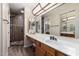 A cozy bathroom with vanity, a shower and a large mirror at 4436 E Shomi St, Phoenix, AZ 85044