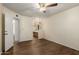 Open bedroom with wood floor, ceiling fan, and partial bathroom view at 4436 E Shomi St, Phoenix, AZ 85044